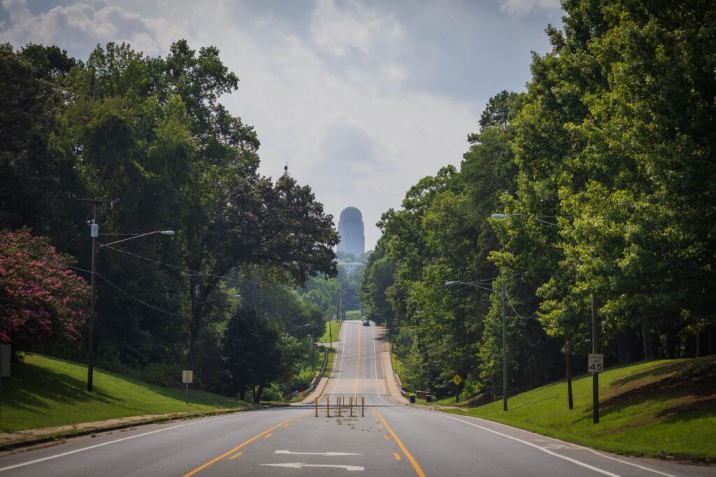 Moving to Winston-Salem: Tree-lined residential street in Winston-Salem with view of downtown skyline in the distance